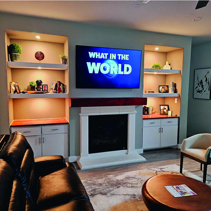 Custom living room remodel with built-in shelves, fireplace, and mounted TV – J Field Construction Texas